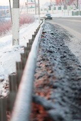 Winter highway with metal safety barrier