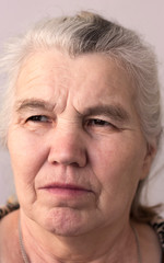 serious woman with gray hair on her head