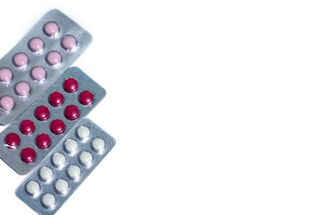 three blister packs of pills on white background