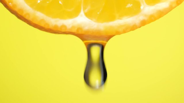 Water dropping on an orange slice , fruit for diet and healthy food. Yellow backgrond