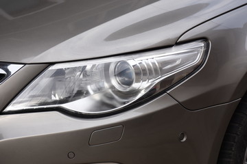 Car's exterior detail,new headlight on a  gray  car