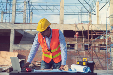 Fototapeta premium Engineer working on construction site with drawing document