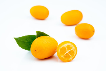 Ripe kumquats on white background