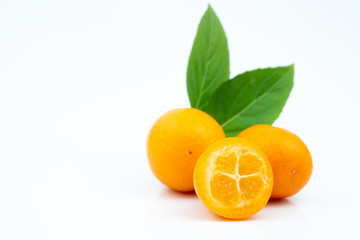 Ripe kumquats on white background