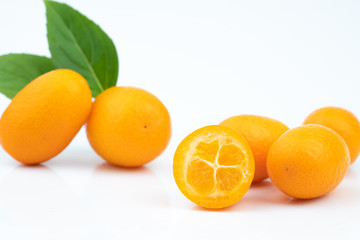 Ripe kumquats on white background
