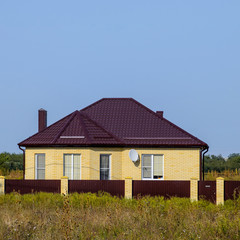 Obraz premium The house with plastic windows and a roof of corrugated sheet