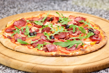 Fresly baked salami italian pizza. Homemade italian pizza with salami and olives. Pizza Quattro Carne.