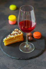 red wine, cake and macaroons, dessert (sweets). food background. top photo