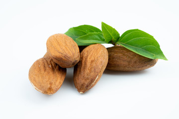 Almond and leaf on white background
