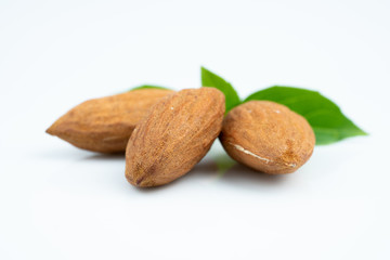 Almond and leaf on white background

