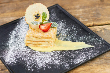 French cake with cream and flour, top view. Delicious french napoleon professionally served.