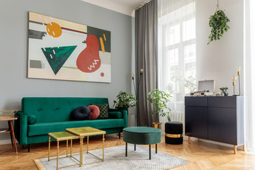 Luxury and modern home interior with design green sofa, navy commode, tables, pouf and accessroies....