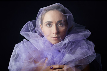Woman wrapped in purple fabric, beautiful slim figure, purity and integrity. Perfect face skincare,...