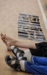 dancers foots, legs, on floor. skeleton picture on the background