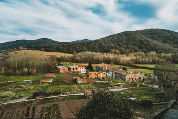 A view of some houses and farm fields from above