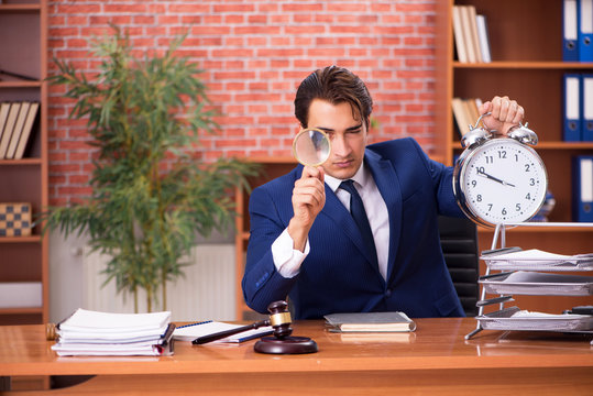 Young handsome lawyer working in his office 