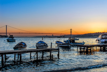 Fototapeta premium Istanbul, Turkey, 17 April 2009: Sunset, Boats and Bosphorus Bridge, Cengelkoy