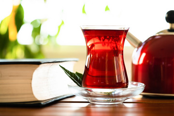 tea, tepot and book on wooden
