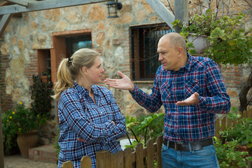 Spouses quarreling in backyard