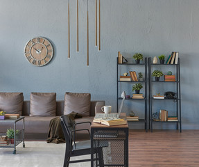 close up working desk and grey room background with sofa and bookshelf, clock sofa book and middle table.