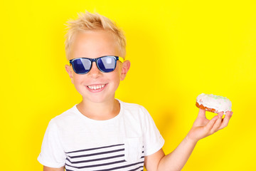 Cute cool blond boy wearing sunglasses looking at camera
