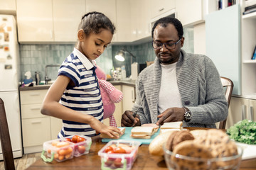 Father and daughter enjoying their family morning cooking together