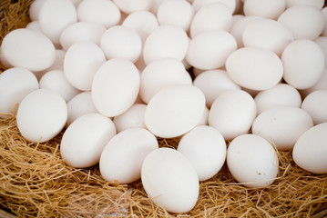 chicken fresh eggs, white, on basket at a local farmers market, ready to be sold, Milan, Italy