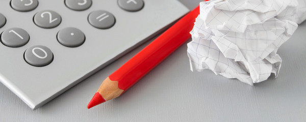 Calculator, paper and red pen