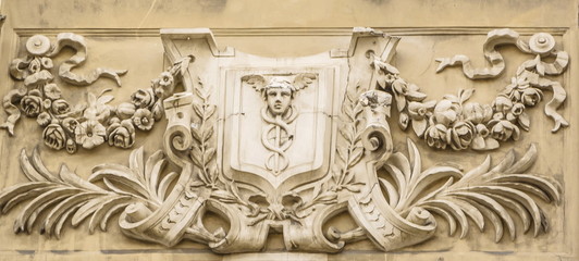 Bas-relief depicting the god of commerce Hermes (Mercury) on the facade of an old house