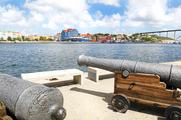 Fototapeta na wymiar Willemstad, Curacao. Dutch Antilles. Colourful Buildings attracting tourists from all over the world. Blue sky sunny day.