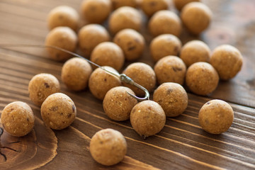Carp baits on a wooden background.