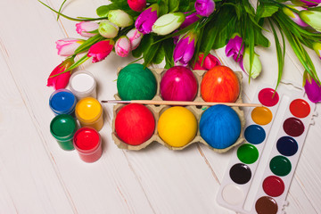 Fototapeta na wymiar tulips with multi-colored Easter eggs