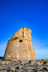 Naklejka premium The ancient watch tower of Porto Miggiano, built on the cliffs overlooking the sea. Bleak and rocky landscape with a splendid view of the sea. Santa Cesarea Terme, Puglia, Salento, Italy.