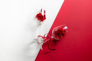Two glasses with rose petals and a bottle of wine for Valentine's Day