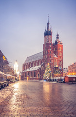 Obraz premium Krakow, Poland, Christmas tree on Main Market Square and St Mary's church