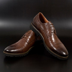 Male fashion with brown shoes on black background