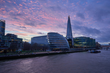 Cityscape of the London city modern architecture including the shard skyscaper and the bank of thames river during the cloudy beautiful sunset, capitol of United Kingdom