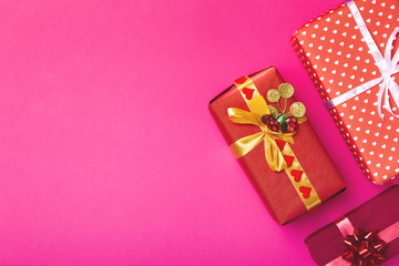background of gifts, boxes wrapped in decorative paper on a colored background, top view, holiday concept