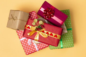 background of gifts, boxes wrapped in decorative paper on a colored background, top view, holiday concept