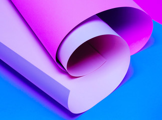 abstract neon colored paper background. Blue, purple and magenta colors.