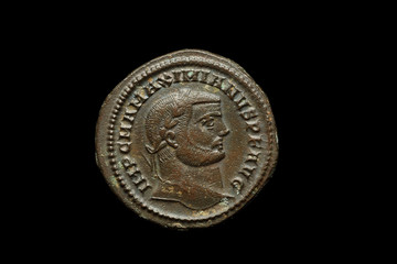 Ancient copper or bronze coin isolated on black, closeup