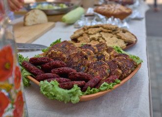 Beef and pork cutlets with onion and lettuce on a plate. Nutrition, ideal for everybody. Close-up.