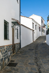 Street in a village of white houses in the Spanish province of Malaga called Casares on a sunny day.