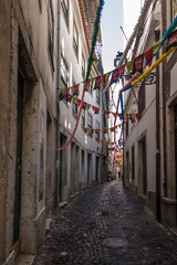 Lisbon, Portugal, June 16, 2018: Old narrow streets in Lisbon with different decorations