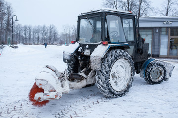 Tractor cleaning snow in a park