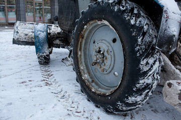Tractor cleaning snow in a park