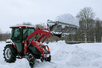 Tractor cleaning snow in a park
