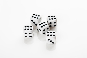 Pile of white with black dots dice with number six on a white background