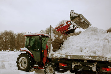 Tractor cleaning snow in a park