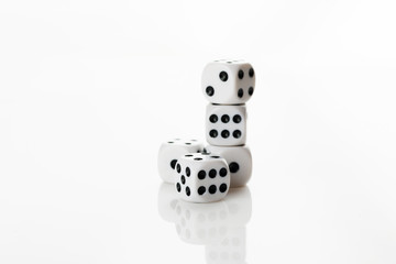 Pile of white with black dots dice on a white background